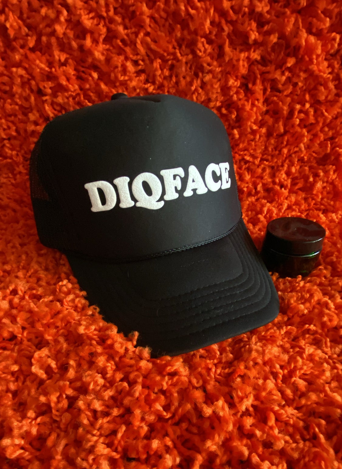 Black cap with 'DIOFACE' text on an orange textured background